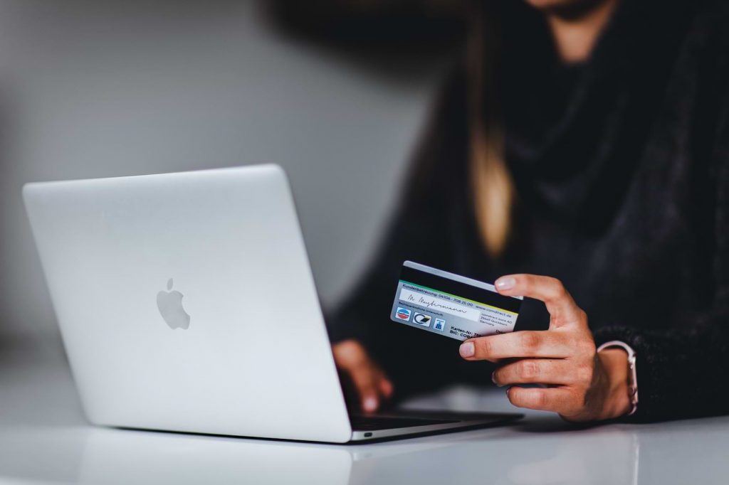 A woman enters her credit card information as she prepares to pay for a new internet plan.