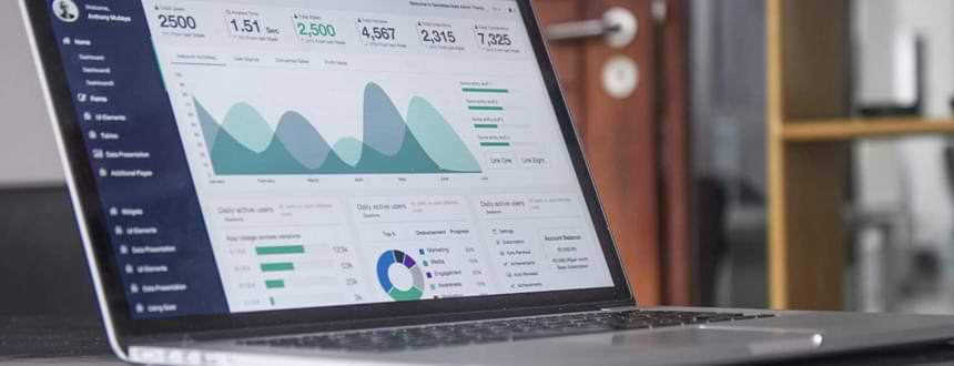 un ordinateur portable posée sur une table avec des statistiques sur l'écran pour savoir Qu'est-ce qu'une bonne vitesse Internet ?